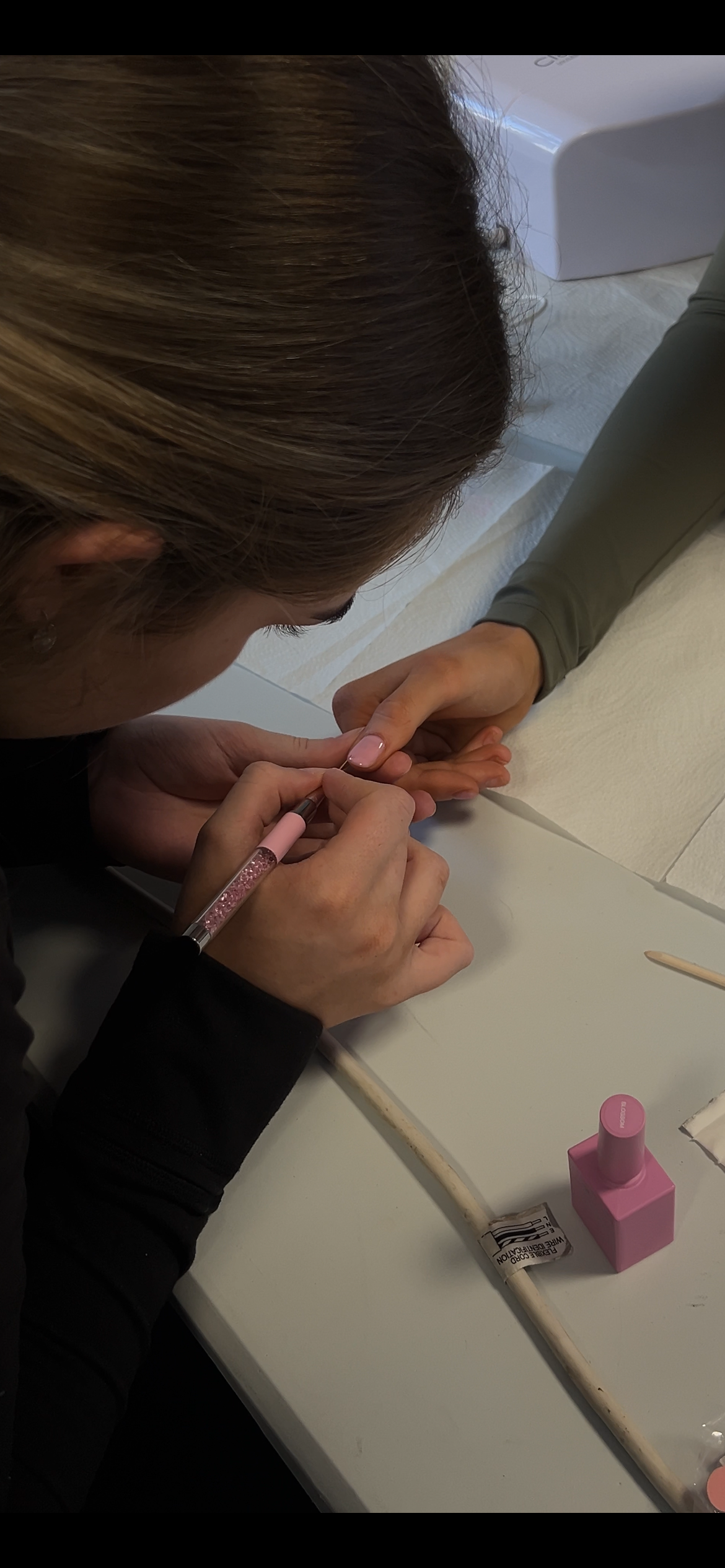 Student practising a nail set during training